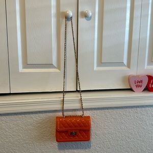 never orange purse with gold chain